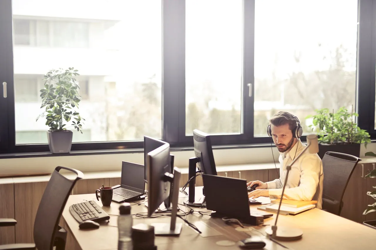 Man with headphones working at a desk